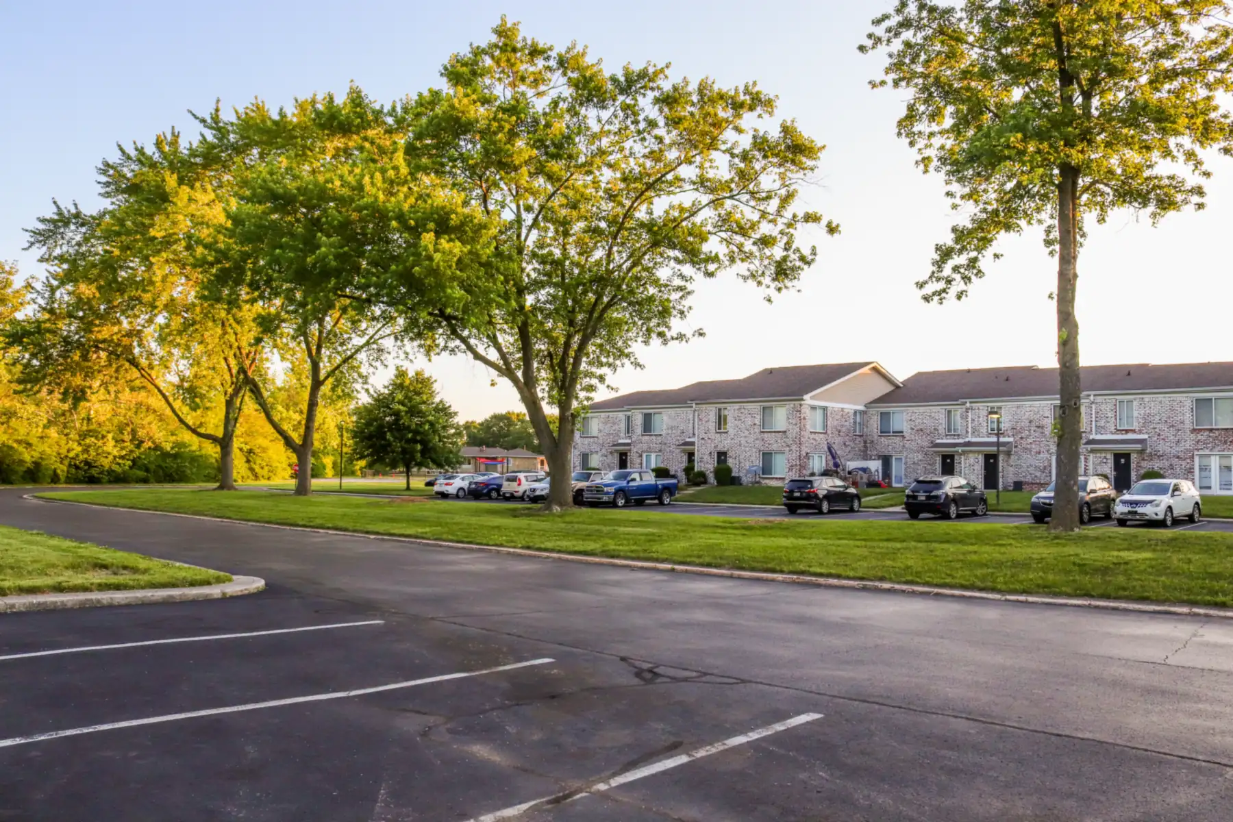 Two-story garden-style apartment buildings with pitched composite shingle roofs