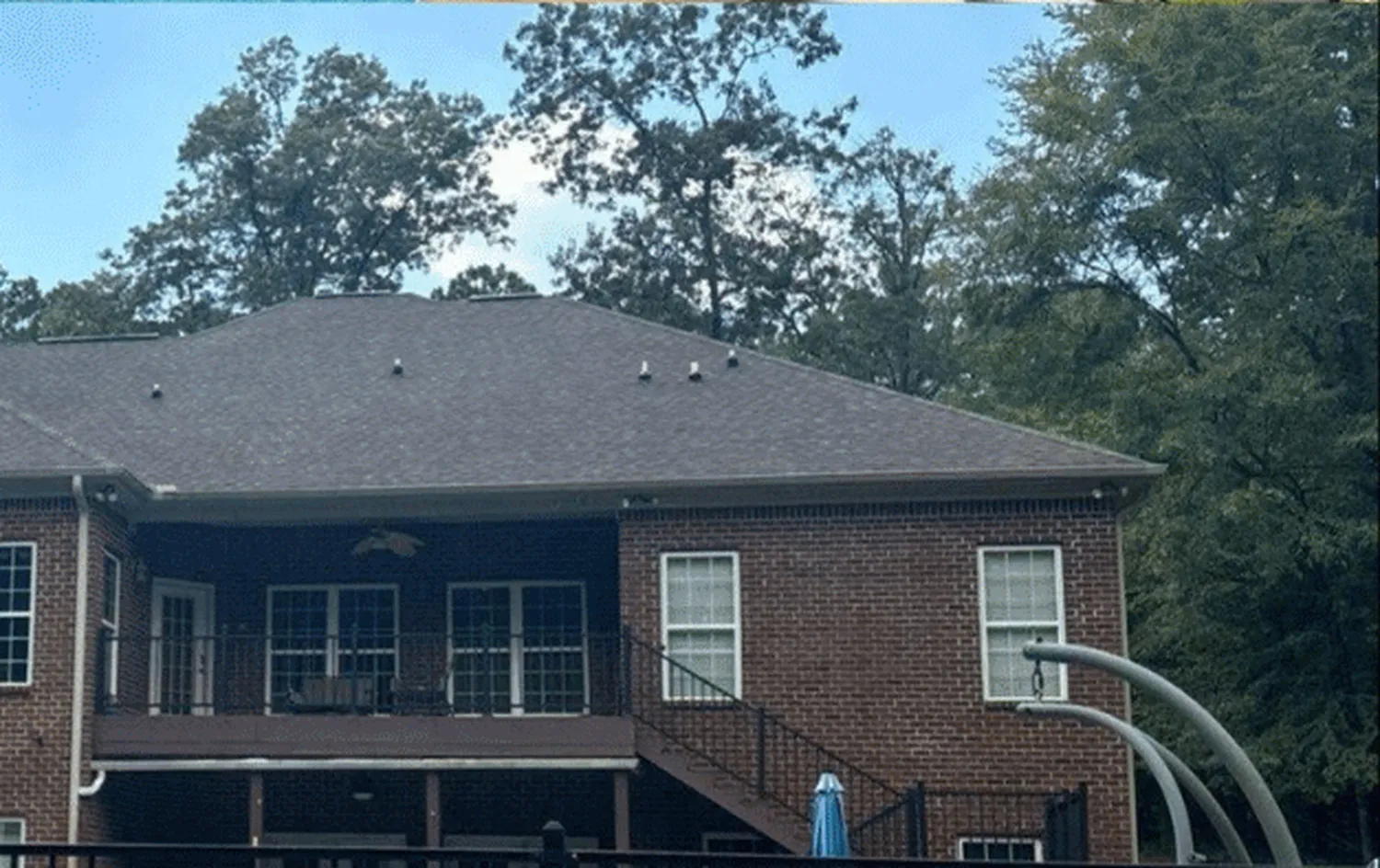 After treatment — two-story brick home, rear elevation